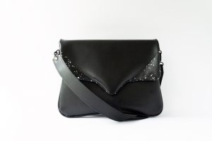 Black purse with white paint spots